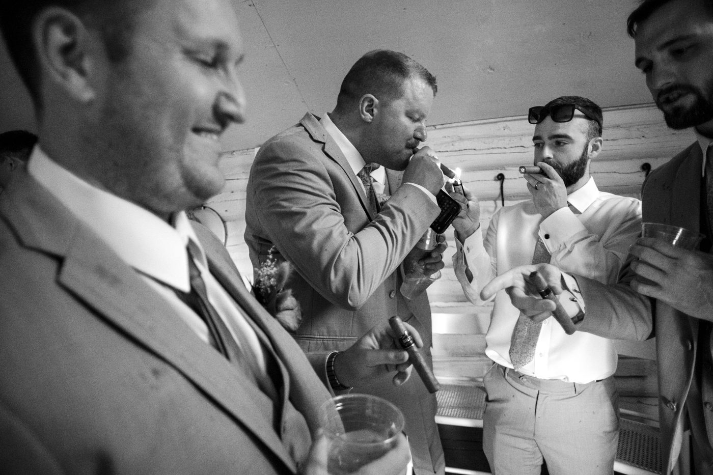 groomsmen-smiling-smoking-cigars-roys-barn