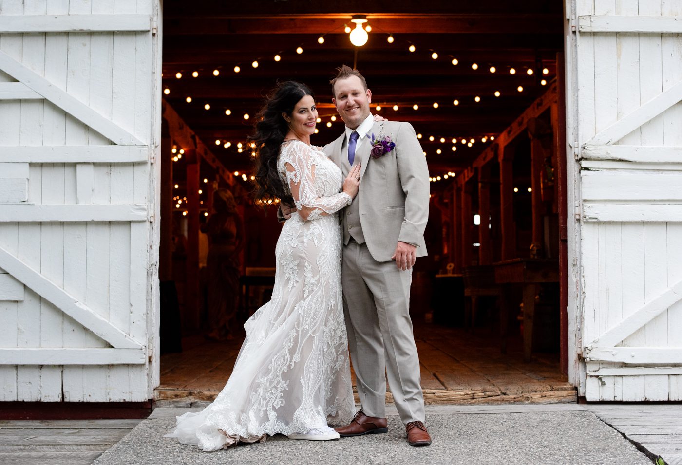 wedding-couple-portrait-in-barn-doorway-at-Roys-Barn