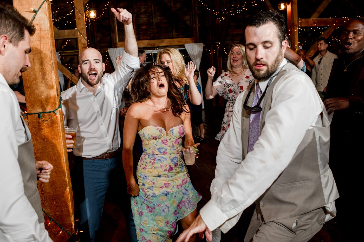 wedding-guests-cheer-and-sing-at-Roys-Barn-destination-wedding-Bozeman-Montana