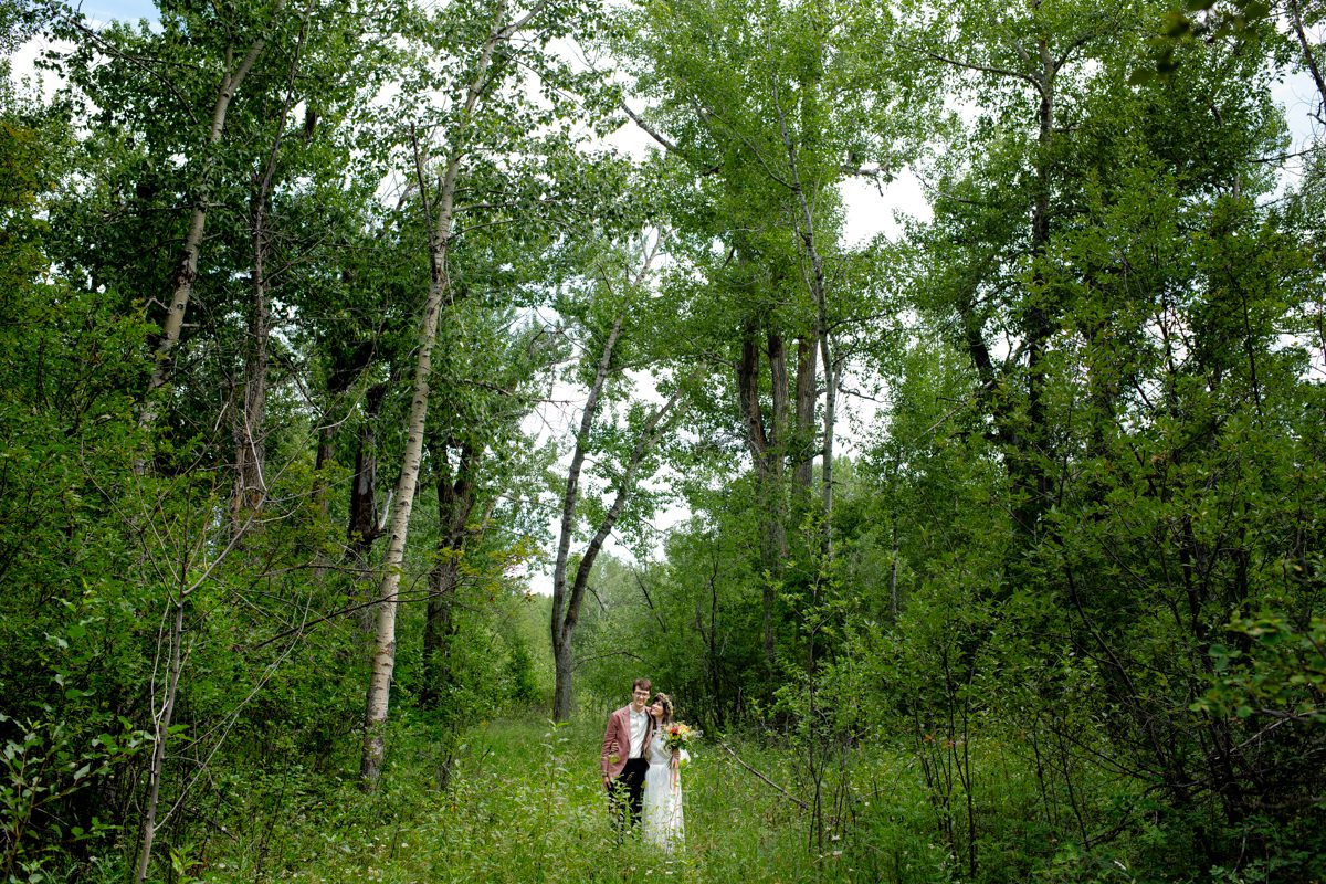 bride-and-groom-in-the-trees-at-Gallatin-River-Hideaway