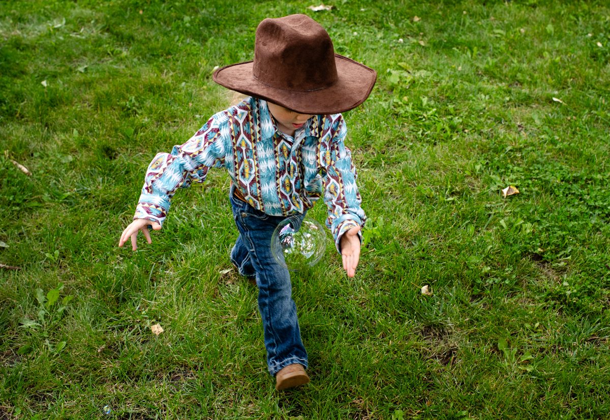 cowboy-kid-chases-bubble-at-Gallatin-River-Hideaway