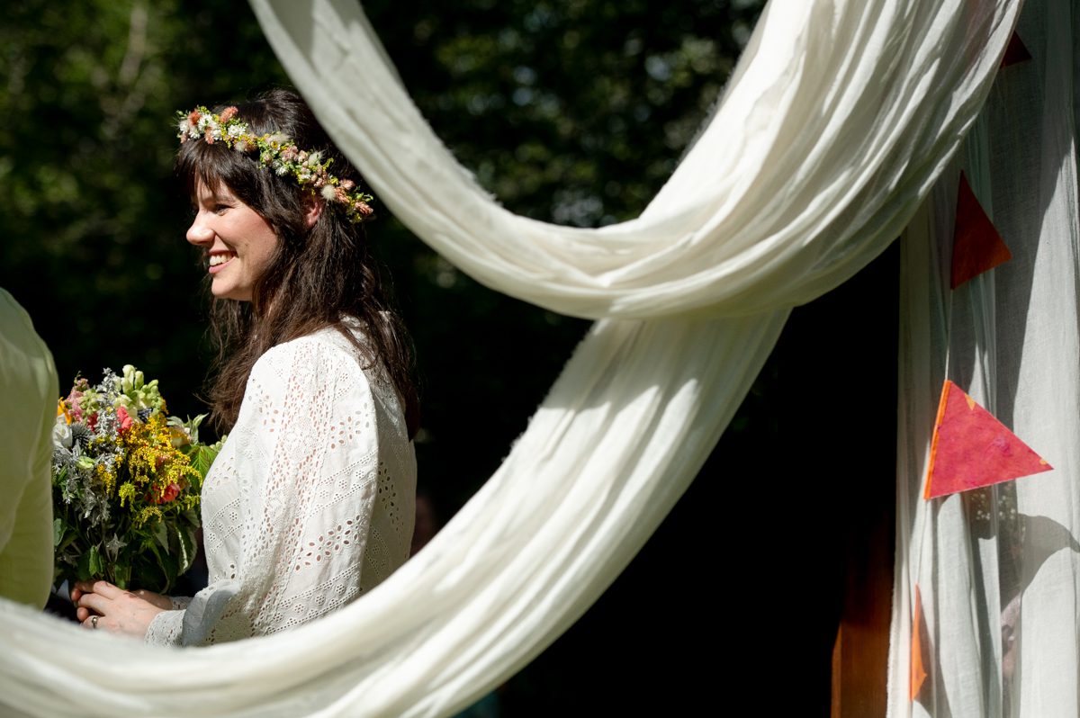 bride-smiles-through-white-drapes-at-Gallatin-River-Hideaway
